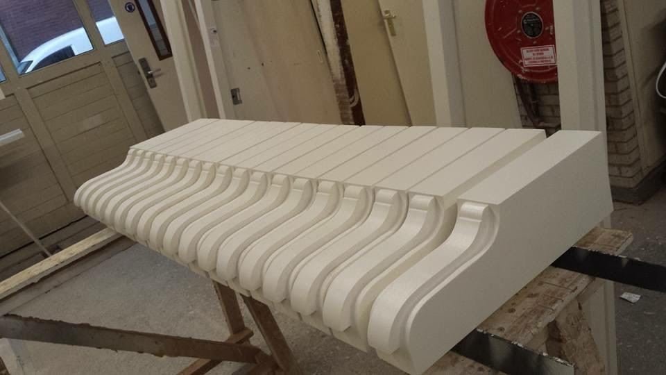 Handmade white timber eaves detail with carved brackets in 1930s style