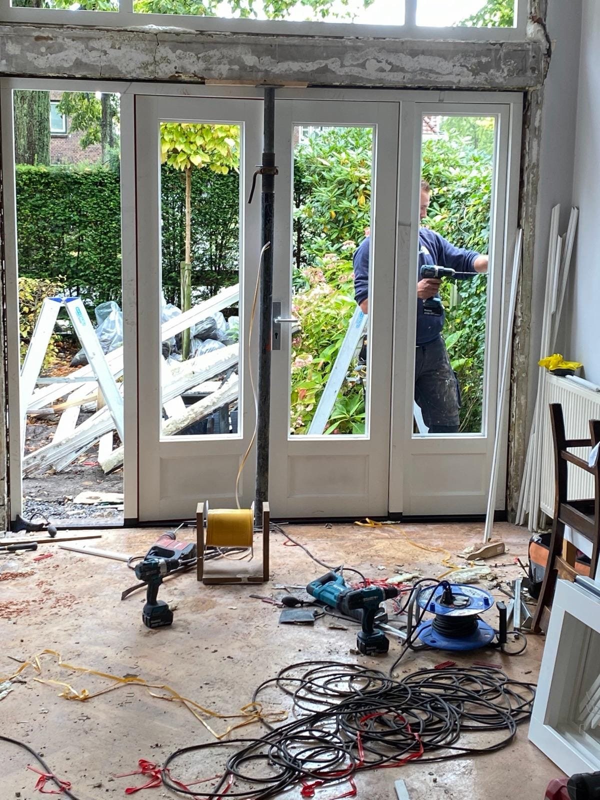 New white timber garden doors seen from inside during the work