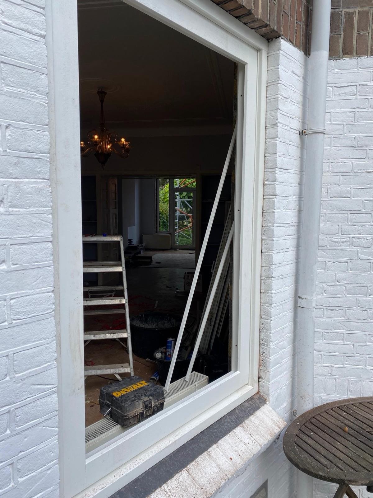 New white timber window frame fitted in a white-painted brick wall